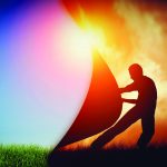 Silhouette of person pulling back landscape to reveal bright day, symbolizing transformation and change.