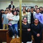 Group gathered at church worship night event, smiling and posing inside the venue.