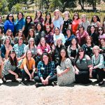 Group photo of women gathered outdoors for a Church of God event, featuring smiles and a scenic background.